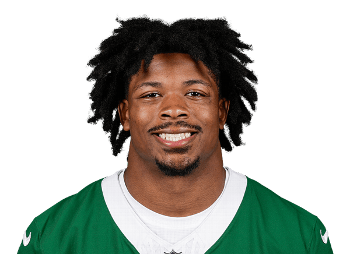 Portrait of a smiling football player wearing a green jersey with a white collar.