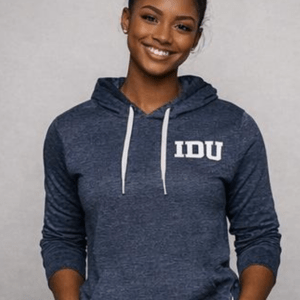 Smiling woman wearing a dark blue hoodie with "IDU" printed on it, posing confidently against a neutral background