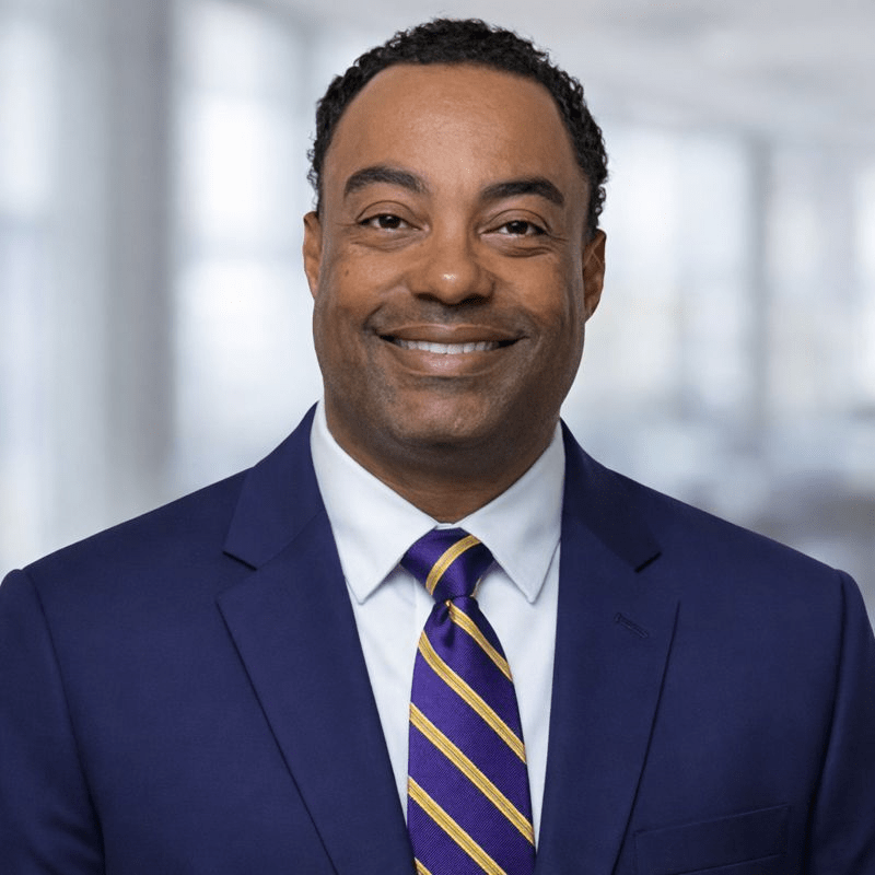 Smiling professional man in a navy suit and striped tie